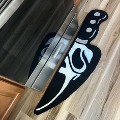 a black and white rug on the floor next to an oven