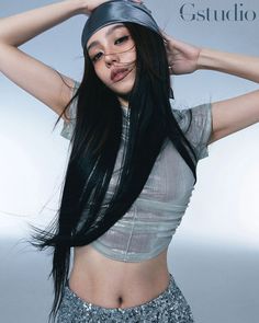 a woman with long black hair is posing for a magazine cover shot wearing a silver top and sequin skirt