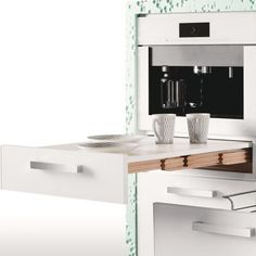 a white kitchen with an oven and coffee maker