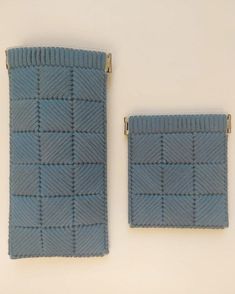 two pieces of blue knitted fabric with gold zippers on white surface, side by side