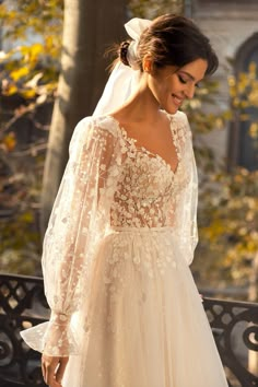 a woman wearing a wedding dress and veil