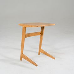 a small wooden table sitting on top of a white floor