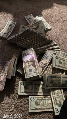 a pile of twenty dollar bills laying on the floor