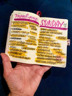 a hand holding an open notebook with some writing on it and the words sunday written in different languages