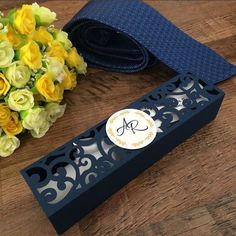 a bouquet of yellow flowers sitting on top of a table next to a blue tie