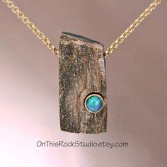 This is a special piece of petrified wood.  It has a fine, delicate quartz druzy surface that glistens in light.  This is completly natural.  The wood is laminated to a piece of black onyx on the back.  And into the front of the petrified is an Australian blue/green opal.  The opal is bezel-set in 14k gold.  These stones are completely natural.  I just put them together. This piece is not large; it measures 1-1/8 inch in height, and a little over 1/2 inch in width, making it a perfect size for f Wood And Stone Jewelry, Silver And Stone Jewelry, Petrified Wood Jewelry, Stone Settings Jewelry, Wood Jewelry Diy, Lapidary Jewelry, Crystal Diy, Wood Jewelery, Wire Wrapped Stone Jewelry