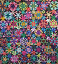 a colorful quilt with many different colors and designs