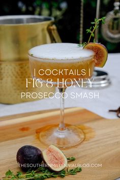 a cocktail with figs and honey on a cutting board