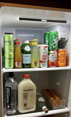 an open refrigerator filled with drinks and condiments