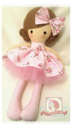 a doll with pink dress and striped socks