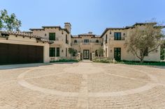 a large house with two garages and a driveway