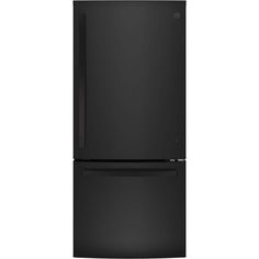 a black refrigerator freezer sitting on top of a white wall