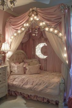 a pink bedroom with a canopy bed and chandelier