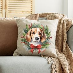 a dog is wearing a wreath on its face and sitting on a couch with pillows