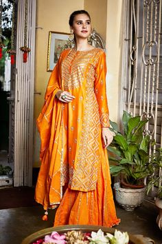 Orange straight kurta with embroidered floral motifs and side slits. Comes with sharara and dupatta.
Component: 3
Embroidery
Neckine: Round
Sleeve Length: Bracelet
Fabric: Silk Chanderi, Organic Cotton
Color: Orange
Hand embroidery
Zari trim detail on pant
Ruffle detail on pant hem
Zari trim detail on dupatta with tassel detail on hem
Closure: Concealed front hook placket on kurta - Aza Fashions Orange Sharara, Embroidered Sharara, Kurta Sharara Set, Kurta Sharara, Pink City, Sharara Set, Indian Fashion Designers, Pernia Pop Up Shop, Modern Branding