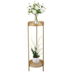 a plant stand with white flowers and greenery in it on an isolated white background