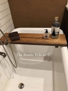 a bath tub with a wooden shelf above it