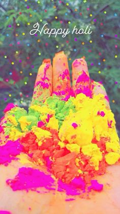 the hand is full of colorful powder and confetti