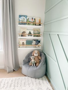 a child's bedroom with a gray bean bag chair and bookshelf on the wall