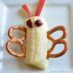 a plate with some pretzels in the shape of a banana and an apple