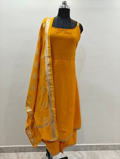 Product Details Yellow Kurta with Palazzos & Dupatta *Kurta design: Solid *A Line shape * Sleeveless * Calf length with flared hem * Silk Blend weave fabric Trousers design: * Solid *Elasticated waistband *Slip-on closure Material & Care Kurta  fabric: Silk Blend bottom fabric: Silk Blend Dupatta fabric: Silk Blend Machine Wash Items Includes One piece kurta One piece Dupatta One piece Palazzo Note:- Please see the size chart in the image to choose a perfect size. Please feel free to ask any que Red Plazo, Dress Kurti, Kurti Palazzo Set, Sleeveless Kurta, Yellow Kurta, Kurti Palazzo, Silk Kurti, Kurta Design, Sleeveless Suit