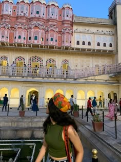 a woman standing in front of a large building