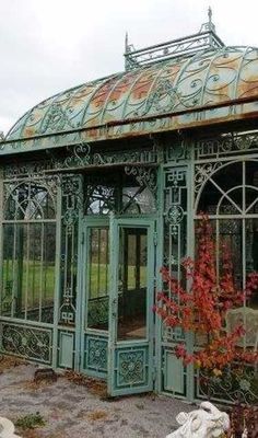 an old green building with glass doors and windows