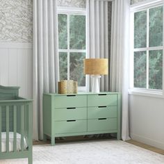 a baby's room with a crib and dresser