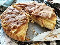 a cake that has been cut into pieces and is on a plate with a knife