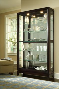 a display case with glass doors in a living room