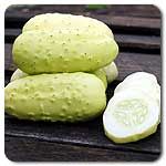 three pieces of cucumber sitting on top of a wooden table next to each other