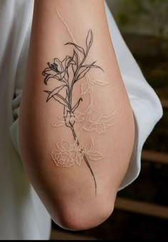 a woman with a flower tattoo on her arm