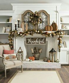 a living room filled with furniture and a fire place covered in christmas decorations on top of a wooden floor