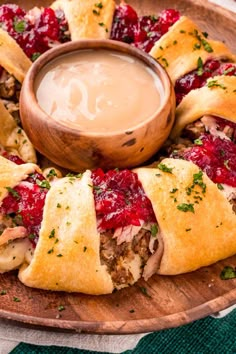 a wooden plate topped with cranberry crescent pastries