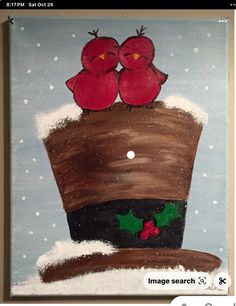 a painting of two red birds sitting on top of a brown hat in the snow