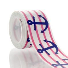 a pink and white striped ribbon with anchors on it