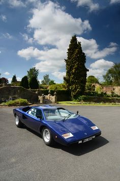 a blue sports car parked in a parking lot