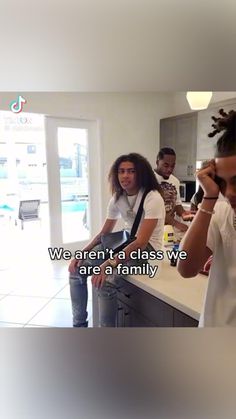 a group of young people standing around a kitchen counter with the words we aren't a class we are a family