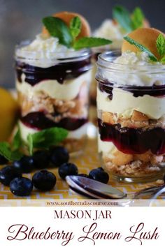 desserts in jars with blueberries, lemon and mint garnish on top