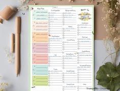 the printable planner is next to some flowers and pencils on top of a table