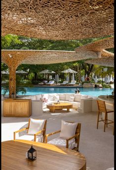 an outdoor dining area next to a pool