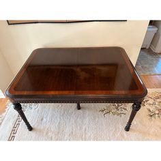 a wooden table sitting on top of a white rug