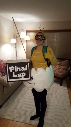 a woman in costume holding a sign that says final lap on the front of her body