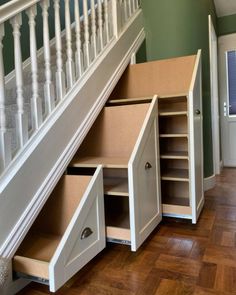 an under stairs storage unit with drawers underneath