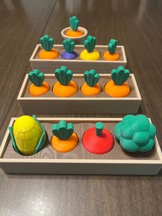 two wooden trays filled with different colored toys on top of a wood table next to each other