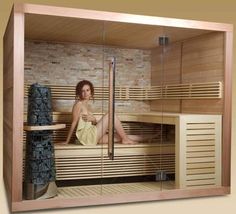 a woman is sitting in a sauna