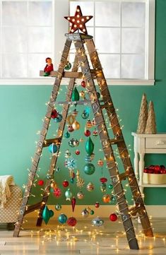 a ladder christmas tree with ornaments hanging from it