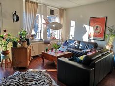 a living room filled with furniture and lots of windows