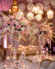 a vase filled with flowers on top of a table covered in white and pink flowers