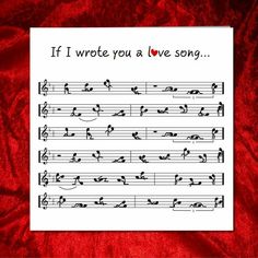 sheet music with the words if i wrote you a love song, on red velvet